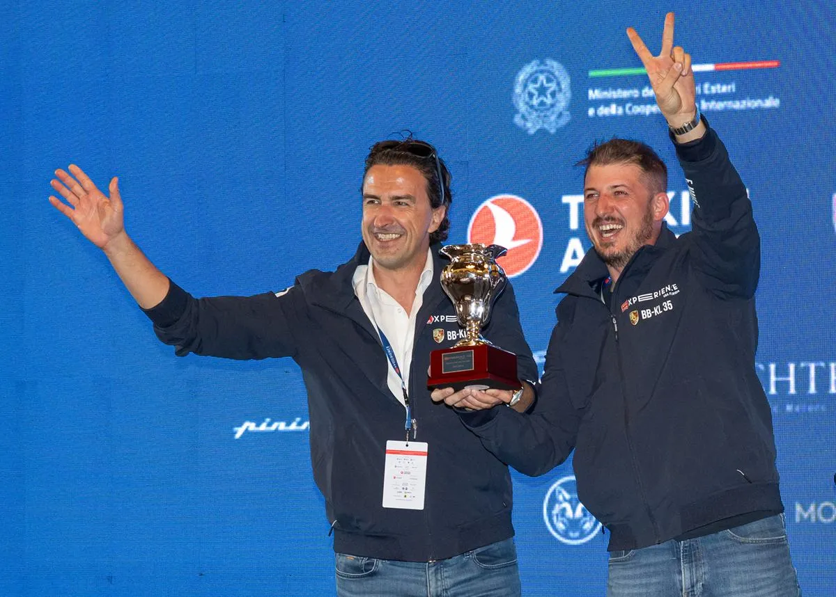 Erick Mahle (right) and his co-driver celebrating on stage with the second-place trophy at the 1000 Miglia Experience USA Florida 2026